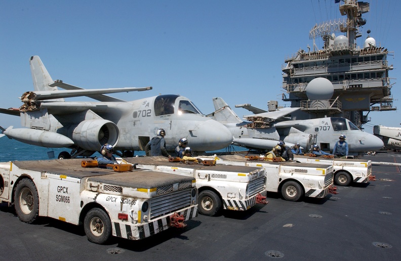 US Navy 030328-N-1810F-007 Tow tractors are positioned on the starboard side of the flight deck in preparation for aircraft movement after the conclusion of daily flight operations aboard the aircraft carrier USS Kitty Hawk (CV - US_Navy_030328-N-1810F-007_Tow_tractors_are_positioned_on_the_starboard_side_of_the_flight_deck_in_preparation_for_aircraft_movement_after_the_conclusion_of_daily_flight_operations_aboard_the_aircraft_carrier_USS_Kitty_Hawk_(CV.jpg US_Navy_030328-N-1810F-007_Tow_tractors_are_positioned_on_the_starboard_side_of_the_flight_deck_in_preparation_for_aircraft_movement_after_the_conclusion_of_daily_flight_operations_aboard_the_aircraft_carrier_USS_Kitty_Hawk_(CV.jpg